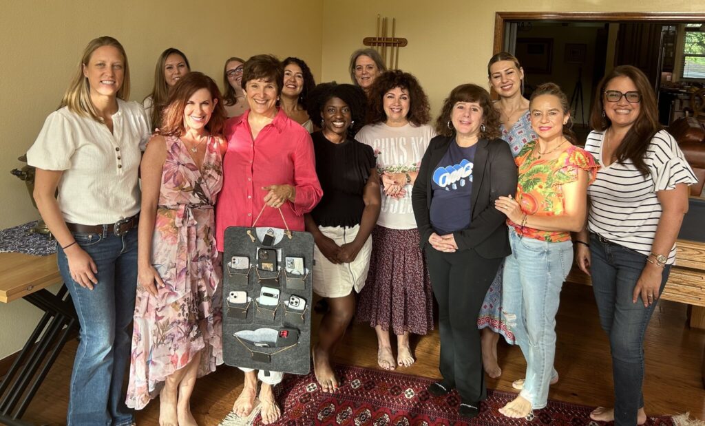 Michelle N. Moore in front of a group of participants and she is holding a bag with the cellphones. This event was an offline event.