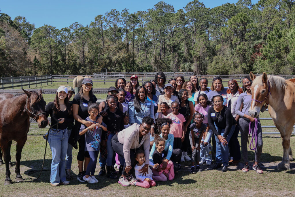 Daughters and Mothers posing with horses at an Orlando Offline Club no devices event.
