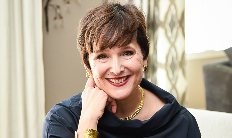 Photo of Michelle N Moore with her hand under the side of her chin.